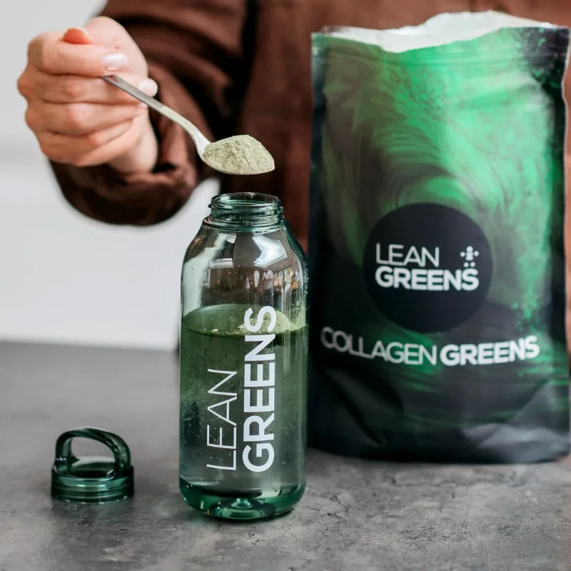 Adding a serving of Collagen Greens powder to a bottle
